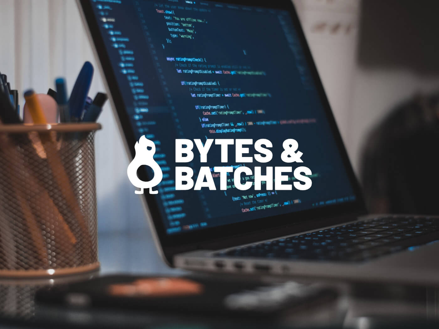 Bytes & Batches - Laptop photography with logo overlay
